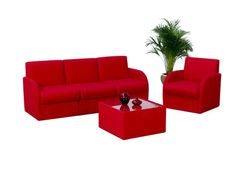 a red couch, chair and coffee table in front of a potted plant