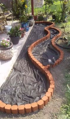 an outdoor garden area is being constructed with bricks and tarp to protect it from the sun