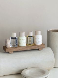 three bottles are sitting on a wooden shelf