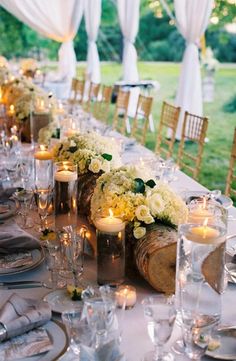 a long table is set with candles and flowers for an elegant dinner party or reception