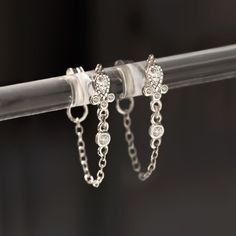 These unique earrings feature a decorative teardrop crystal center with a long chain connected to the earring backs. Looks great worn alone or paired with other earrings. .925 Sterling Silver Cubic Zirconia Crystals Hypoallergenic post Teardrop Crystal Height 3mm x 2mm Chain drop: 16mm #E593 Elegant Dangle Cartilage Earrings With Adjustable Chain, Elegant Silver Dangle Cartilage Earrings, Silver Drop Cartilage Earrings For Wedding, Silver Drop Earrings With Adjustable Chain, Elegant Sterling Silver Teardrop Cartilage Earrings, Silver Sterling Cartilage Earrings With Diamond Accents, Elegant Teardrop Sterling Silver Cartilage Earrings, Silver Dangle Cartilage Earrings For Anniversary, Elegant Sterling Silver Dangle Cartilage Earrings