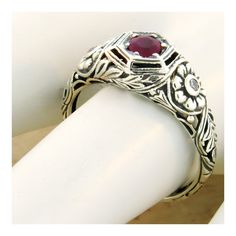 Vintage Estate Natural Ruby Filigree Ring. Cubic Zirconia Accent Stones. Intricate Floral Details. 925 Solid Sterling Silver. The Top Of The Ring Measures Just Over 1/4 Inch In Length. Set With One 4 mm Round Faceted Natural Ruby With 2 Cubic Zirconia Side Stones. Stamped 925. Excellent Condition/Like New. Classic Round Gemstone Flower Ring, Classic Ruby Ring With Round Stone In Sterling Silver, Classic Silver Ruby Birthstone Ring, Classic Silver Birthstone Ring With Ruby, Heirloom Sterling Silver Engraved Ring With Gemstone, Sterling Silver Engraved Ring With Accent Stones, Elegant Engraved Sterling Silver Birthstone Ring, Classic Adjustable Flower Ring For Anniversary, Adjustable Victorian Rings For Anniversary