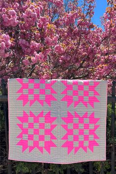 Neon pink patchwork quilt against pink cherry blossoms Neon Quilt Ideas, Ruby Star Society Quilt, Xmas Quilts, 16 Patch Quilt, Granny Square Quilt, Alphabet Quilt, Sunflower Patch, Charm Pack Quilt, Modern Quilt Pattern