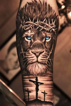 a man's arm with a lion and cross on it