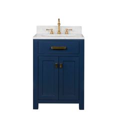 a bathroom vanity with a gold faucet on top and a blue cabinet underneath it