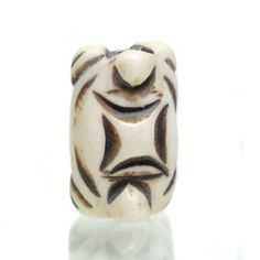 a white and brown bead with black lines on it