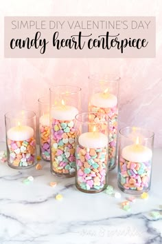 some candles that are in glass vases with confetti on the bottom and one is filled with candy