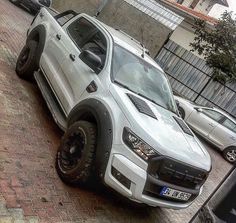 a white truck parked on the side of a road