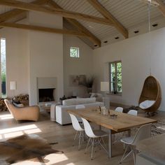 a living room filled with furniture and a fire place in the middle of a room