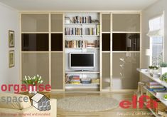 a living room with an entertainment center and bookshelves