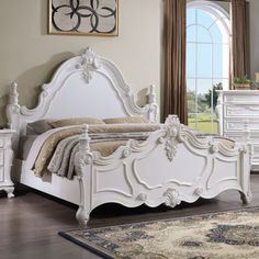 a white bed sitting in a bedroom next to a dresser and mirror on top of a hard wood floor