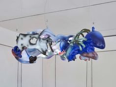 several blown glass sculptures hanging from the ceiling