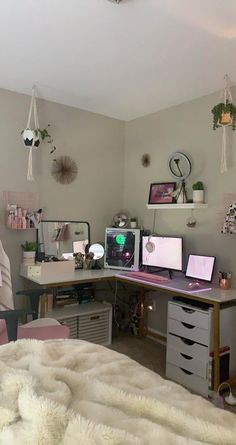 a bedroom with two computer desks and several other items on the wall above it