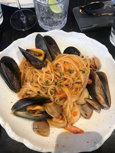 pasta with clams and shrimp on a white plate