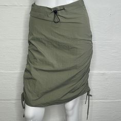 Women's Skirt Brand Mayblanc Size Xs Color Green (Army Green) Lined No Button None Drawstring Waist Length Above Knee Pockets None Fabric 100% Nylon Zipper On The Side Condition New Measurements Please Refer To The Following Measurements To Insure A Proper Fit. All Measurements Are Approximate. Waist Side To Side Seam 13 1/4 Inches Zipper Length 7 Total Length 22 1/2 Casual Stretch Nylon Skirt, Casual Nylon Stretch Skirt, Casual Fitted Nylon Skirt, Fitted Nylon Casual Skirt, Casual Ruched Nylon Bottoms, Casual Mini Skirt With Ruched Sides, Skirt Cargo, Batik Skirt, Zara Tweed