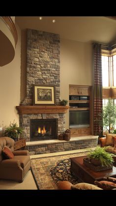 a living room filled with furniture and a fire place in the middle of a room