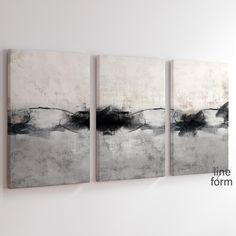 three black and white paintings hanging on the wall