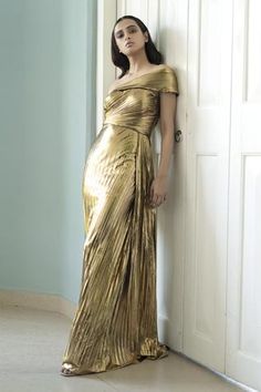 Shop for Shivani Awasty Gold Lame Pleated Metallic Gown for Women Online at Aza Fashions Chic Gold Gown For Gala, Gold Gown For Cocktail Gala, Gold Cocktail Gown For Gala, Chic Gold Cocktail Gown, Glamorous Pleated Evening Dress For Formal Occasions, Glamorous Pleated Evening Dress For Formal Events, Chic Gold Formal Gown, Metallic Pleated Dress For Gala, Elegant One-shoulder Metallic Dress