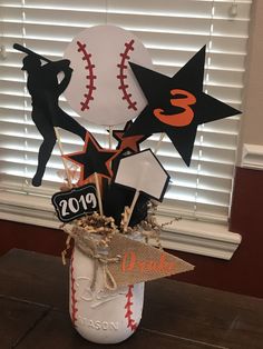 a baseball themed centerpiece in a vase