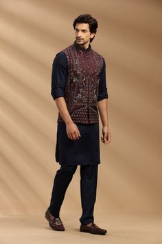 Top Details Color- Wine/Navy Blue, Fabric - Soft Suiting Fabric With Embroidered Bottom Details Color- Navy, Fabric - Suiting Fabric, Style - Aligadi Pajama Package Include :INCLUDES 1 BANDI,1 KURTA,1 ALIGADI. Turban ,Mojari And Other Accessories Are Not Sold Along With The Dress. CARE: DRY CLEAN ONLY Additional Information : - As This Sherwani/Waistcoat/Kurta Are Made As Per Orders So It Is Strictly Not Acceptable Once Get Delivered .So Kindly Choose Body Fit Size . Also We Keep 2 Inches Extra Jodhpuri Kurta Pajama Men, Nehru Jacket With Dabka Work For Navratri, Unstitched Nehru Jacket For Designer Wear Navratri, Unstitched Designer Nehru Jacket For Navratri, Unstitched Chanderi Nehru Jacket For Eid, Sleeveless Kurta With Dabka Work For Eid, Traditional Sleeveless Nehru Jacket For Eid, Bollywood Style Unstitched Nehru Jacket For Navratri, Traditional Sleeveless Bandhgala For Eid