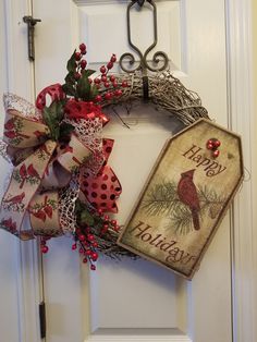 a christmas wreath with a happy holidays tag hanging from the front door to give it a festive feel