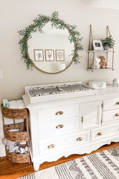 a baby crib in the corner of a room with a mirror and other items