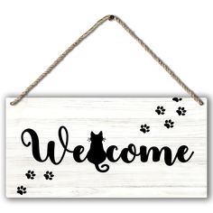 a wooden sign that says welcome with paw prints