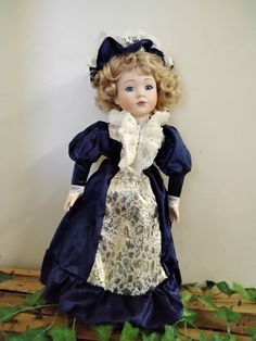 a doll with blonde hair wearing a blue dress