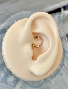 a close up of a ring on top of a plastic container with water in it