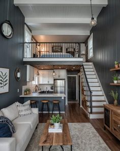 a living room filled with furniture and a staircase