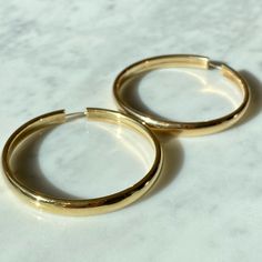 "Solid 14K Italian made Gold Hoops - Looking for an amazing classic gold hoop that will last you a lifetime? This is the hoop! - A classic solid gold look with a flat inner circle creating an edge. - An endless closer meaning you open differently than a lever back. The endless closure creates a look that the hoops goes all around. - 100% 14K gold, meaning they do not change the color of your ear or ever rust. If taken care of, they will easily last a lifetime. Can be taken on vacation and for a Gold Meaning, Cross Choker, Beaded Cross, Inner Circle, Classic Gold, Gold Hoops, The Endless, Gold Hoop, On Vacation