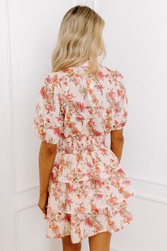 - This mini dress is perfect for a romantic lunch date with your sweetheart! - Unlined lightweight material with a pink, yellow, and orange hued floral design - A v-cut neckline that goes into a button-down bodice - Short sleeves with elastic cuffs - A wide smocked waistline - A tiered skirt - A figure flattering silhouette that ends in a straight mini dress length hemline Measurements S : Bust 36", Hip 36", Length 31.5", Sleeve Length 12", Waist 24-36". M : Bust 38", Hip 38", Length 31.5", Slee Pink Floral Print V-neck Mini Dress, Feminine Peach Mini Dress For Vacation, Feminine Apricot Dress With Floral Print, Feminine Apricot Floral Print Dress, Peach V-neck Mini Dress For Beach, Feminine Orange Mini Dress For Day Out, Peach Mini Dress For Spring Vacation, Apricot V-neck Mini Dress For Summer, Summer V-neck Mini Dress In Apricot