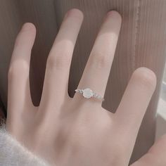 This White Rose Ring screams romance with its beautifully detailed rose design. Say "I love you" in a unique and elegant way with this delicate ring! ◆ Materials: 18k white gold plating Hypoallergenic solid sterling silver base Eco resin Cubic zirconia stones ◆ Size: Adjustable open design for size 5+ ◆ Please Note: When adjusting the ring, please squeeze or expand the ring body slowly and gently. Rose Gold Cubic Zirconia Flower Ring As A Gift, Elegant Rose Flower Ring For Gift, Elegant Rose Flower Ring As Gift, Elegant Rose-colored Flower Ring For Gift, Elegant Rose Colored Flower Ring As Gift, Elegant Rose-colored Flower Ring As Gift, Elegant White Gold Crystal Ring For Valentine's Day, Elegant Sterling Silver Rose Design Flower Ring, Silver Diamond Jewelry With Rose Design