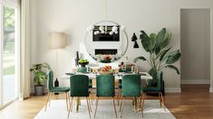 a dining room table with green chairs and a round mirror on the wall above it