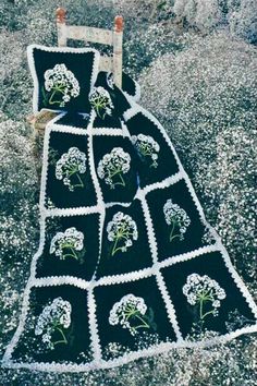 a black and white afghan with flowers on it