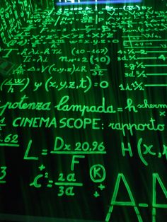 a table topped with lots of green writing on top of it next to a window