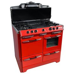 an old fashioned red stove with two burners