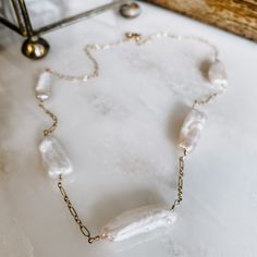 Vacay vibes that can be dressed up while being versatile enough to wear with a plain tee! Five freshwater pearl sticks with mixed link chain. Added adjustability with jump ring connections to make the perfect fit! Available in 14k gold fill or sterling silver. 16”-18” or 18”-20” chain length options. Everyday 14k Gold Filled White Chain Necklace, Everyday White 14k Gold Filled Chain Necklace, Minimalist Pearl Necklace With Paperclip Chain, White Pearl Necklace With Paperclip Chain, Vacay Vibes, Plain Tees, Jump Rings, Link Chain, Chain Lengths