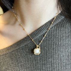 This dainty baroque pearl pendant necklace is a beautiful and distinctive accessory that would make a great addition to any jewelry collection. The pendant features a 10mm round natural baroque pearl, adding to its charm and individuality. The gold vermeil material gives it a sleek and elegant appearance. Material: - Made in gold vermeil: a thick 18k gold layer on sterling silver - Baroque pearl Measurements: - Chain length: 40cm + 6cm extender - Pendant height: 19mm; width: 12mm - Pearl size: 1 Gold Pearl Round Pendant Charm Necklaces, Gold Pearl Charm Necklaces With Round Pendant, Elegant Pearl Charm Necklaces For Jewelry Making, Elegant Pearl Chain For Jewelry Making, Elegant White Charm Necklace With Round Pendant, Elegant White Round Pendant Charm Necklace, Pearl Pendant Charm Necklace, Pearl Pendant Charm Necklaces, Baroque Pearl Necklace With Round Pendant