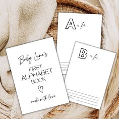 two baby names and the first alphabet book written in cursive writing on white paper