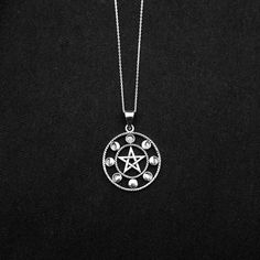 "Real 925 Sterling Silver Moon Phases Pentacle Charm Necklace This simple yet elegant necklace features a sterling silver Moon Phases Pentacle on a Dainty Sterling silver 18\" cable chain. Charm Measures 40 x 29mm Jewelry will come in a gift box * Please read shop policy before placing an order * *JEWELRY CARE* Sterling Silver will tarnish over time, but to help keep your jewelry looking beautiful - Clean with a soft dry cloth after wear and store inside an airtight bag or container. Remember to Mystical Round Silver Jewelry, Mystical Silver Round Jewelry, Nickel Free Mystical Sterling Silver Necklace, Symbolic Sterling Silver Round Charm Necklaces, Mystical Sterling Silver Jewelry Stamped 925, Nickel Free Round Mystical Necklace, Mystical Sterling Silver Necklace In Silver, Mystical Round Sterling Silver Necklace, Symbolic Round Necklaces Stamped 925