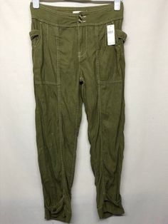 AA6 Has a tiny hole on the left tie belt, not visible at all By Anthropologie Tie-Waist Tapered Utility Trousers Khaki Pants Crop Size US 2 Measurement laying flat Waist Across:   15"   Hip:    18" Inseam:   26" Length:  36" CONDITION: Excellent New with tag condition. This is the photos of the actual item you will receive. Please examine the photos carefully as they are part of the description. I want you to be happy with your purchase and since sizes vary so much, please go by the true measure Olive High-waisted Bottoms With Pockets, High-waist Olive Pants With Pockets, Olive High-waist Pants With Pockets, Olive High Waist Utility Bottoms, High Waist Military Style Cotton Bottoms, High Waist Olive Cotton Pants, Military Style High-waist Bottoms With Belt Loops, Relaxed Fit Military Bottoms With Belt Loops, Olive Pants With Pockets For Fall