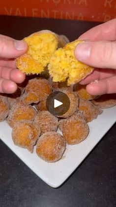 two hands grabbing food from a white plate