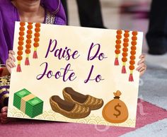 a woman holding up a sign that says maise do jotte lo with money and shoes