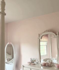 a white dresser and mirror in a room