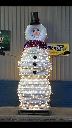 a snowman made out of stacks of books and lights