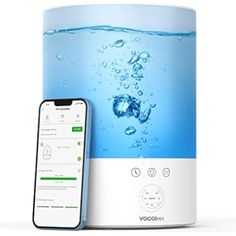 an appliance with water on the screen next to it and a cell phone