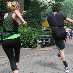 a man and woman are running in the park