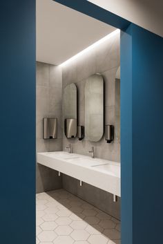 a public restroom with three sinks and urinals on the wall in front of mirrors