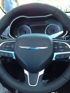 the interior of a car with steering wheel controls